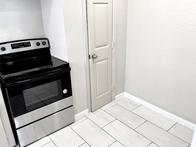 kitchen with electric stove and light tile patterned floors