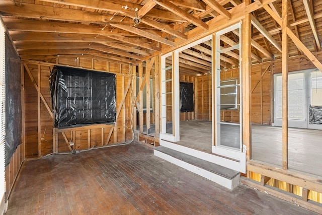 miscellaneous room with lofted ceiling and hardwood / wood-style floors