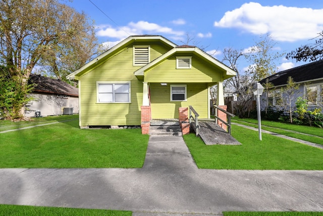 bungalow-style home featuring a front lawn and central air condition unit