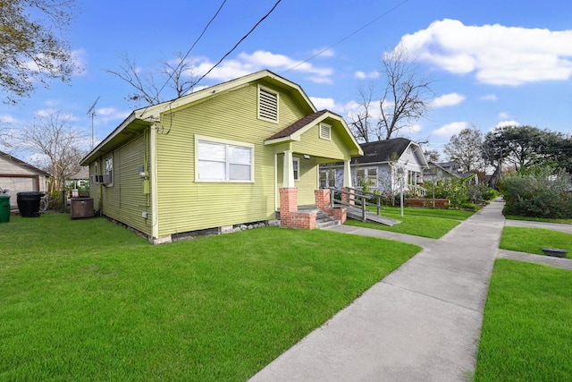 bungalow-style house with a front lawn