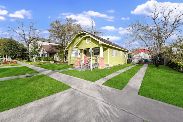 bungalow-style home featuring a front yard