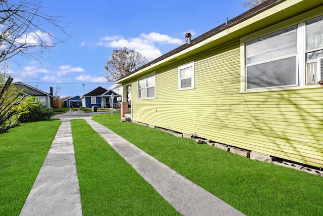 view of side of home featuring a yard