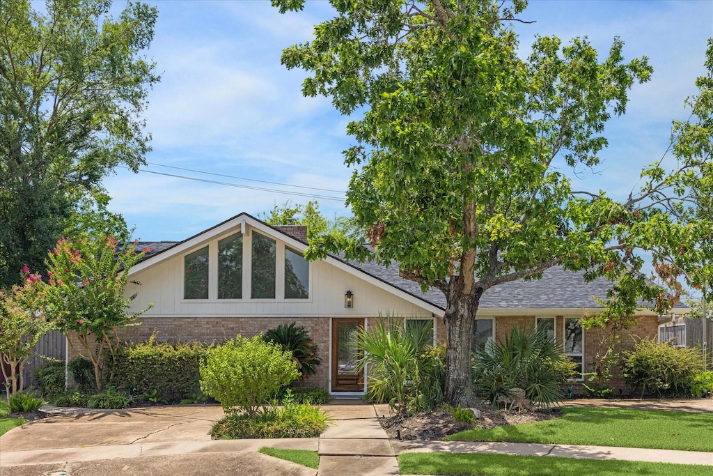 mid-century inspired home featuring brick siding