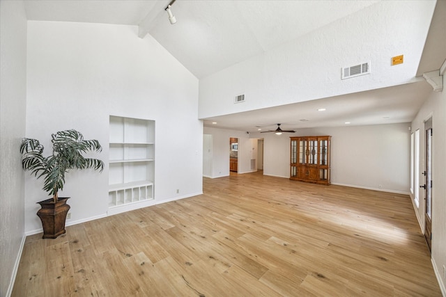 unfurnished living room with ceiling fan, light hardwood / wood-style flooring, track lighting, high vaulted ceiling, and built in shelves