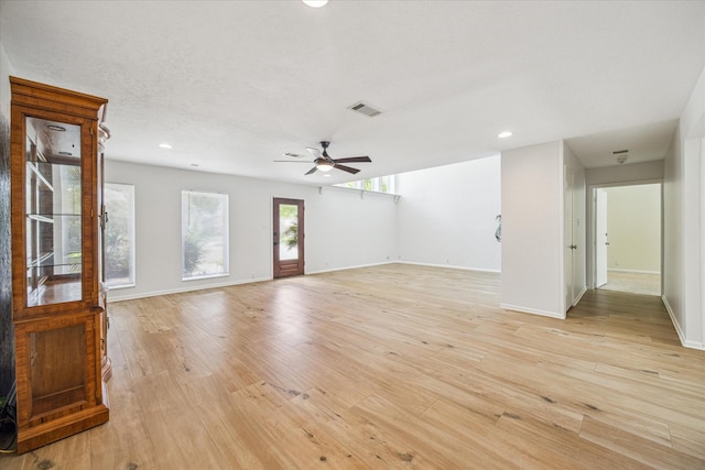 unfurnished living room featuring light wood-type flooring and ceiling fan