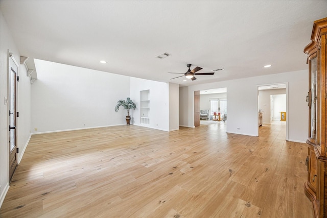 unfurnished living room featuring ceiling fan and light wood-type flooring