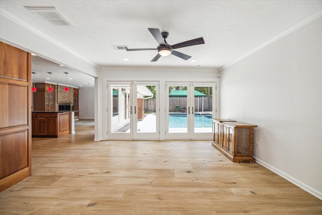 interior space with ceiling fan, ornamental molding, light hardwood / wood-style floors, and french doors