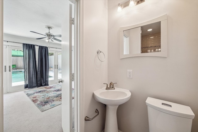 bathroom with ceiling fan and toilet