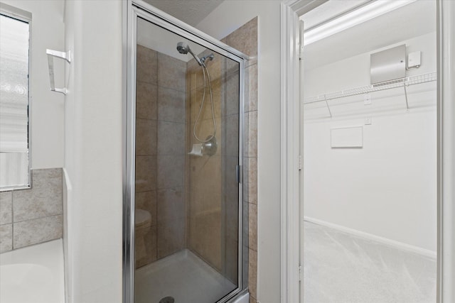 bathroom featuring a shower with shower door