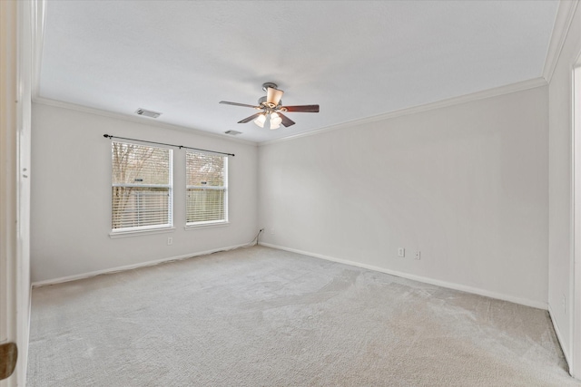 carpeted spare room featuring ceiling fan and ornamental molding