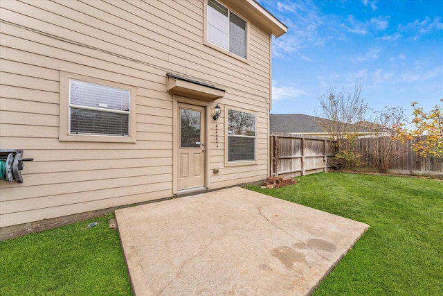 doorway to property with a patio area and a yard