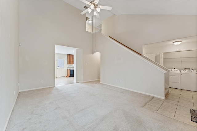 unfurnished living room featuring ceiling fan, light colored carpet, washing machine and clothes dryer, and high vaulted ceiling