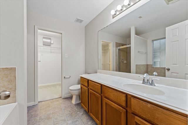 bathroom featuring an enclosed shower, vanity, and toilet