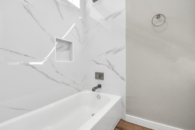 bathroom featuring tub / shower combination and hardwood / wood-style floors