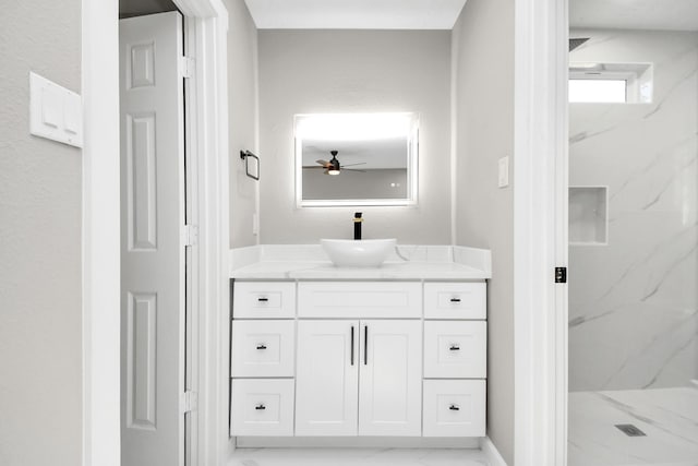 bathroom featuring ceiling fan, walk in shower, and vanity