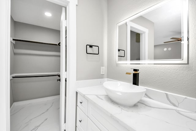 bathroom featuring ceiling fan and vanity