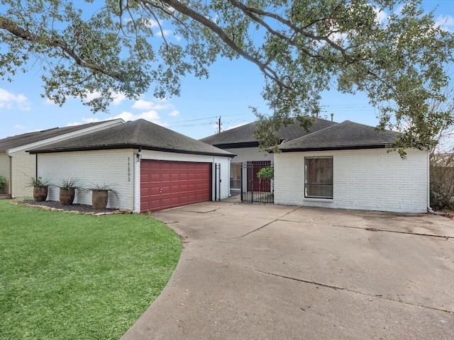 ranch-style home featuring a garage and a front yard