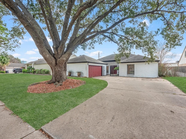 ranch-style home with a front lawn and a garage