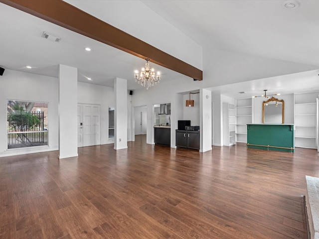 unfurnished living room featuring a chandelier, dark hardwood / wood-style floors, built in features, and a towering ceiling