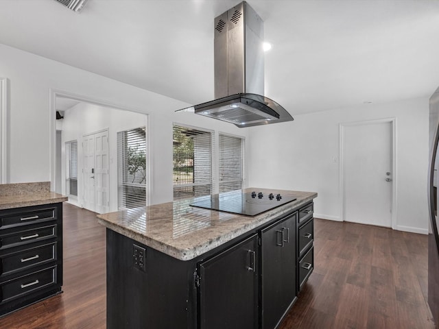 kitchen with light stone countertops, a center island, dark wood-type flooring, island range hood, and black electric cooktop