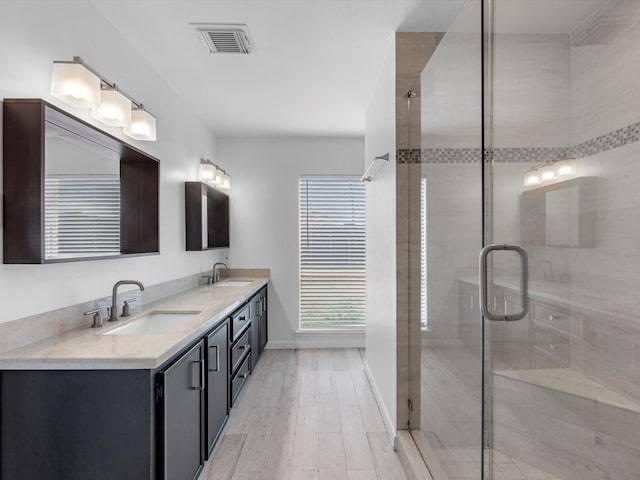 bathroom featuring vanity, a shower with door, and hardwood / wood-style floors