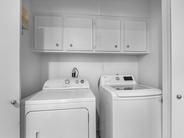 laundry area with cabinets and separate washer and dryer