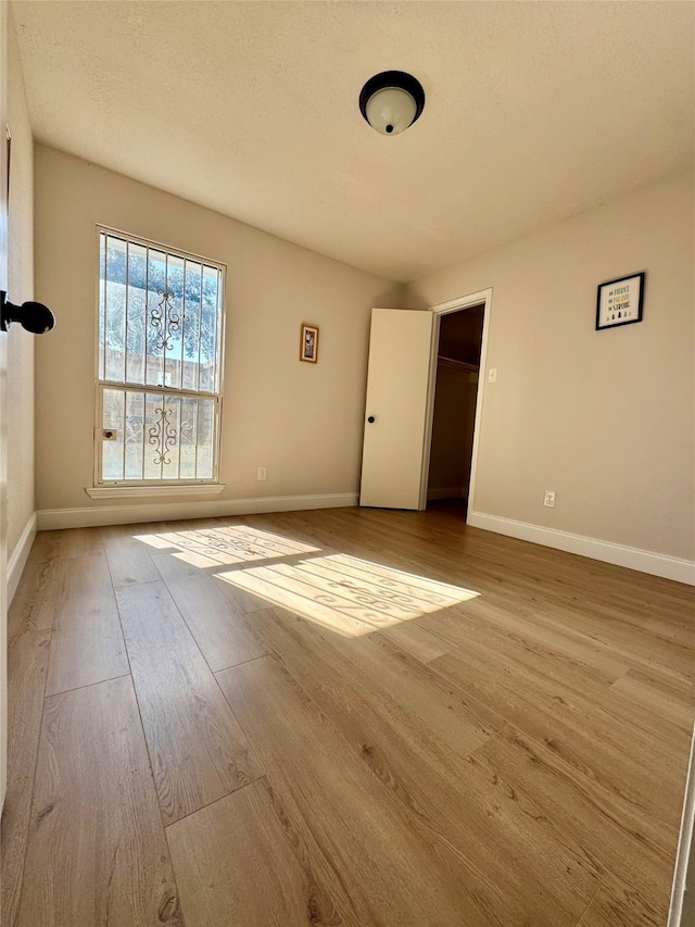 spare room featuring light hardwood / wood-style floors