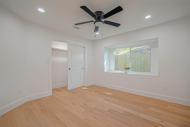 unfurnished bedroom with ceiling fan, light hardwood / wood-style floors, and a closet