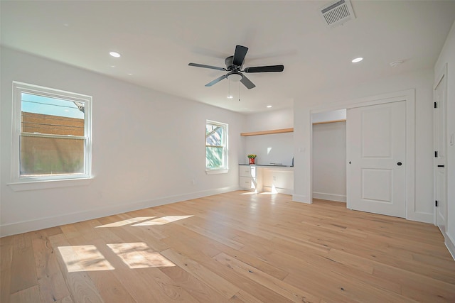 unfurnished living room with light hardwood / wood-style floors and ceiling fan