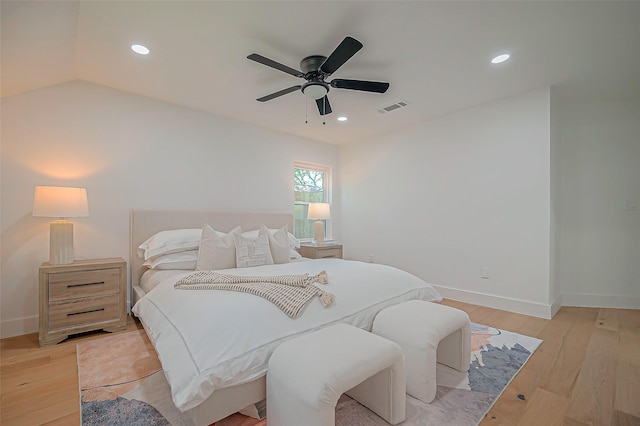 bedroom featuring ceiling fan, light hardwood / wood-style flooring, and vaulted ceiling