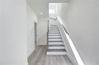 staircase featuring wood-type flooring