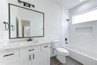 full bathroom featuring bathtub / shower combination, toilet, and vanity