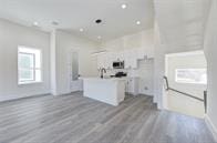 kitchen featuring white cabinetry and hardwood / wood-style floors