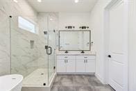 bathroom featuring vanity and separate shower and tub