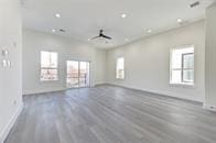 empty room featuring ceiling fan and hardwood / wood-style flooring