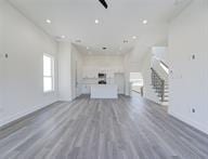 unfurnished living room featuring hardwood / wood-style floors