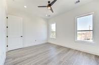 spare room featuring ceiling fan and light wood-type flooring