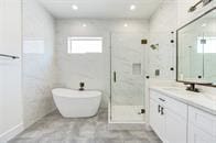 bathroom featuring vanity and plus walk in shower