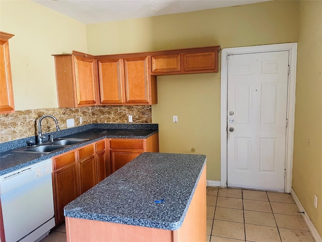 kitchen with decorative backsplash, sink, light tile patterned flooring, white dishwasher, and a center island