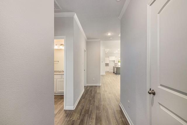 hall featuring dark wood-type flooring and ornamental molding