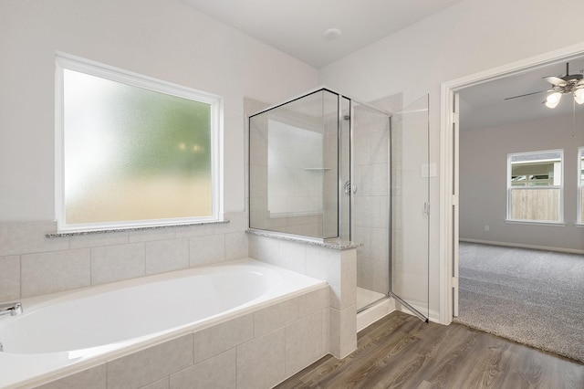 bathroom featuring ceiling fan, wood-type flooring, and separate shower and tub