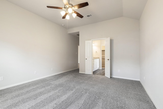 unfurnished bedroom featuring ceiling fan, dark carpet, and lofted ceiling