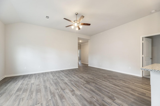 unfurnished room featuring ceiling fan, lofted ceiling, and hardwood / wood-style flooring