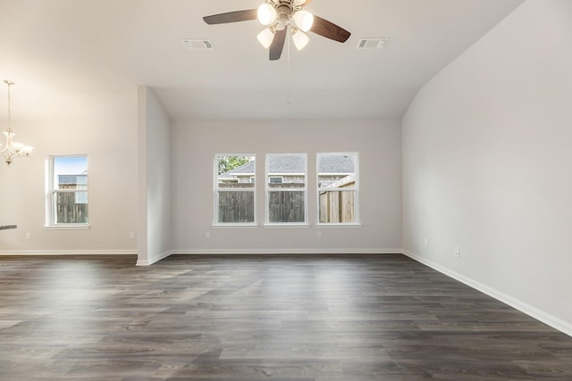 unfurnished room featuring dark hardwood / wood-style flooring, lofted ceiling, and ceiling fan with notable chandelier