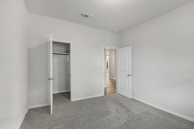 unfurnished bedroom featuring a closet and carpet flooring