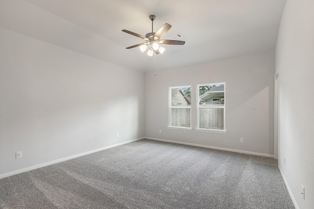 empty room featuring ceiling fan and carpet