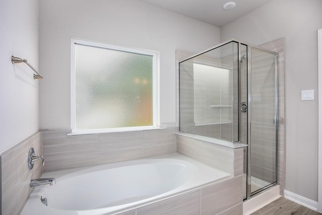 bathroom with separate shower and tub and hardwood / wood-style floors