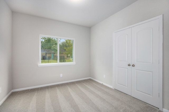 unfurnished room with light carpet