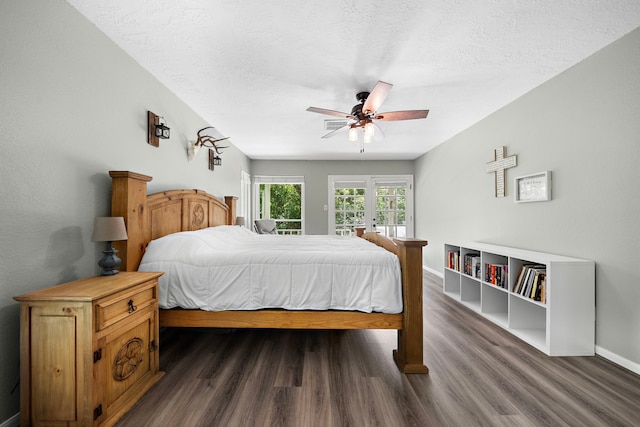 bedroom with a textured ceiling, ceiling fan, and dark hardwood / wood-style flooring