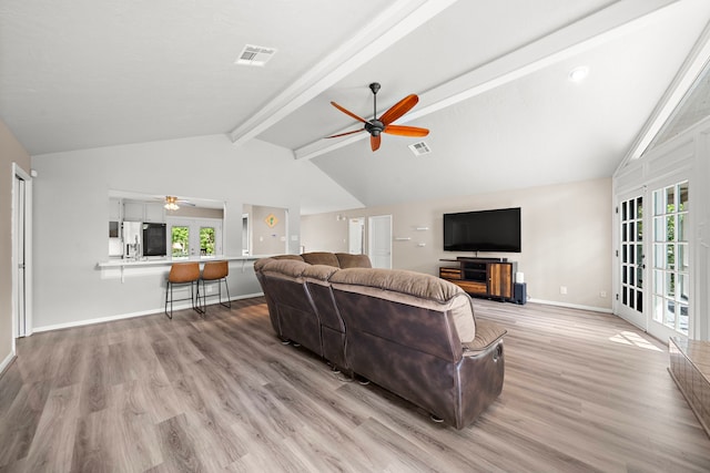 living room featuring ceiling fan, lofted ceiling with beams, french doors, and light wood-type flooring